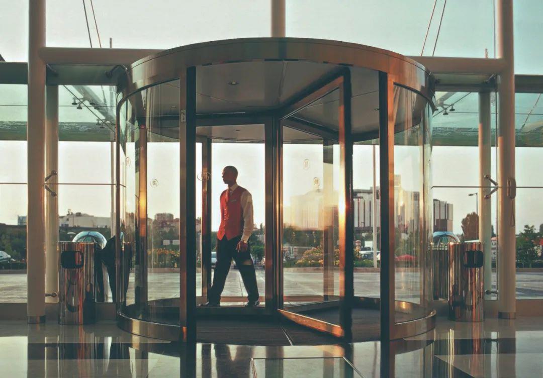 Why do many hotels install revolving doors?